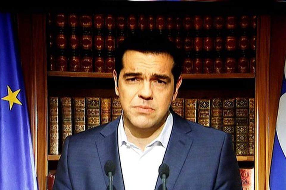 Greek Prime Minister Alexis Tsipras is seen on a television monitor while addressing the nation in Athens, Greece July 1, 2015