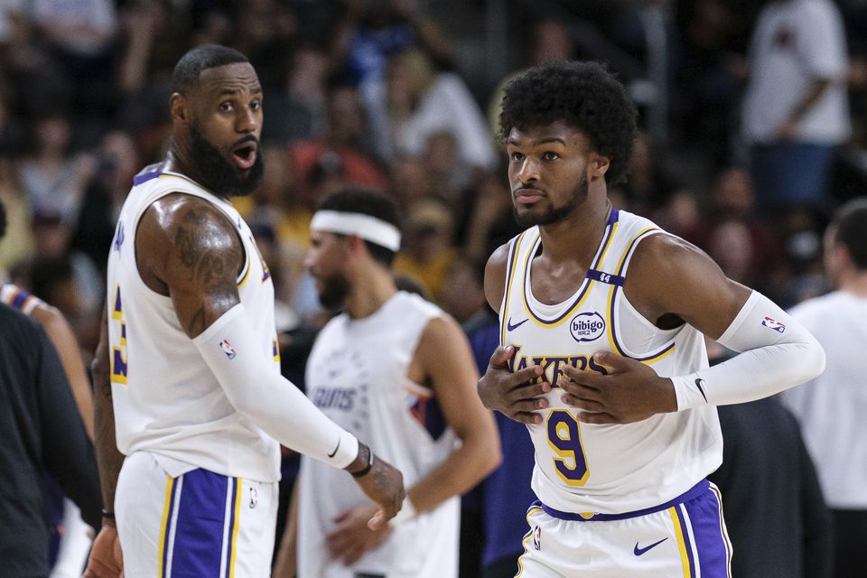 Los Angeles Lakers guard Bronny James, right, steps onto the court with his father LeBron James in Palm Desert, California (William Liang/AP)