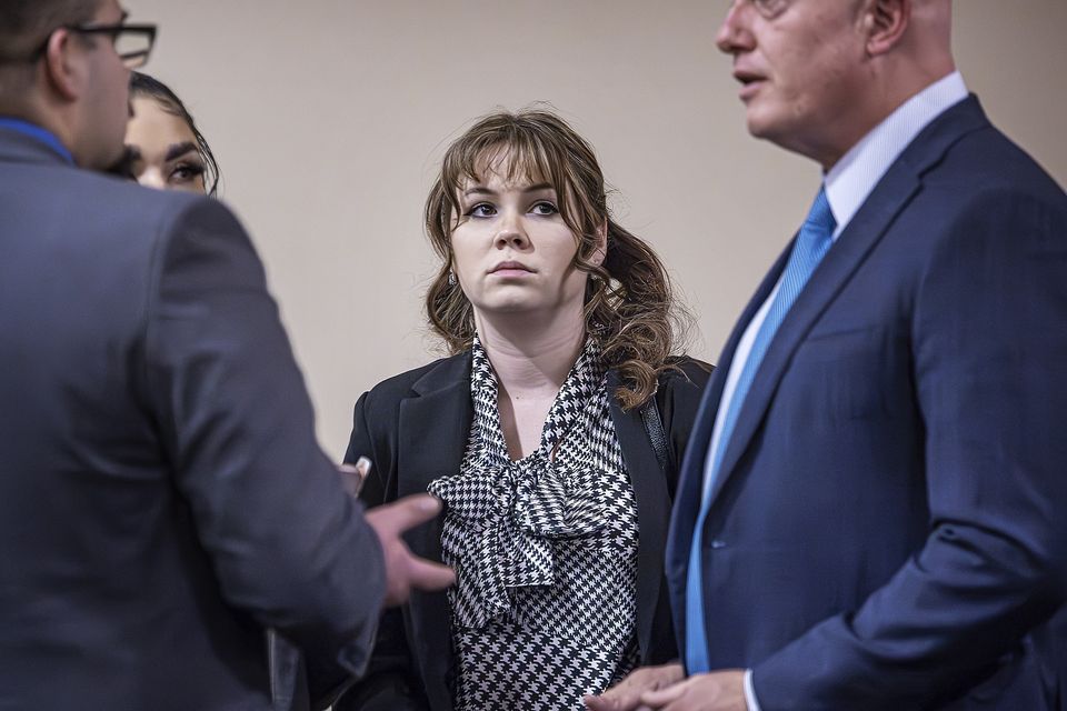 Rust movie armorer Hannah Gutierrez-Reed talks with her lawyer Jason Bowles, right, and her defence team (Jim Weber/Santa Fe New Mexican via AP, Pool)
