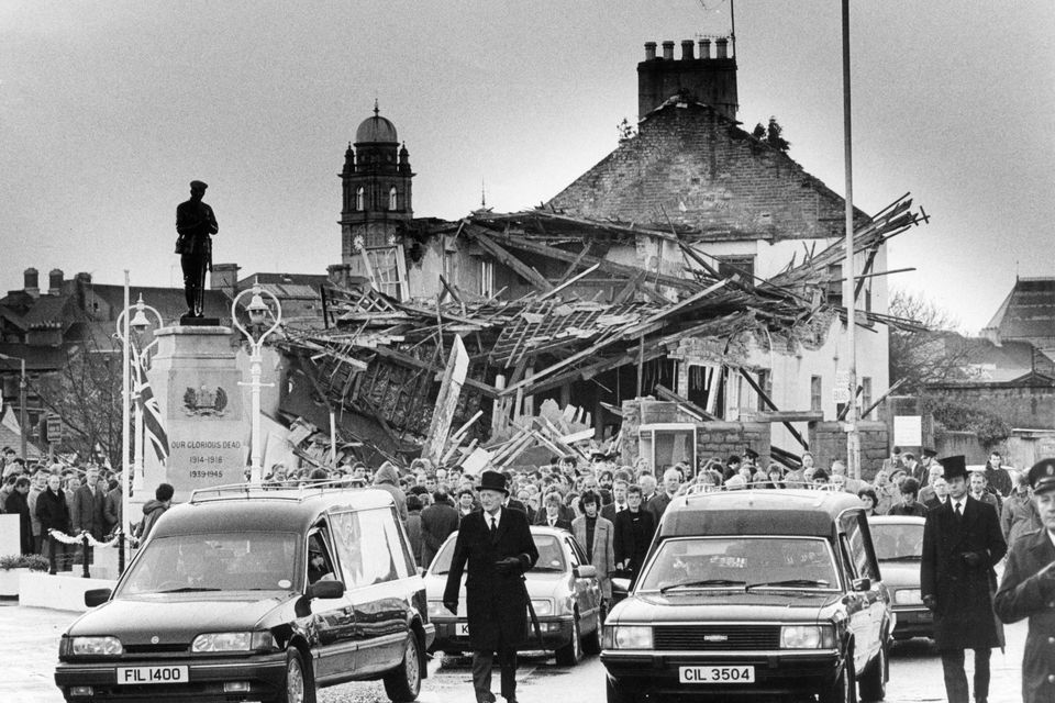 A funeral cortage is led past the cenotaph and scene of explosion which killed them in Enniskillen in November 1987. Photo by John Carlos