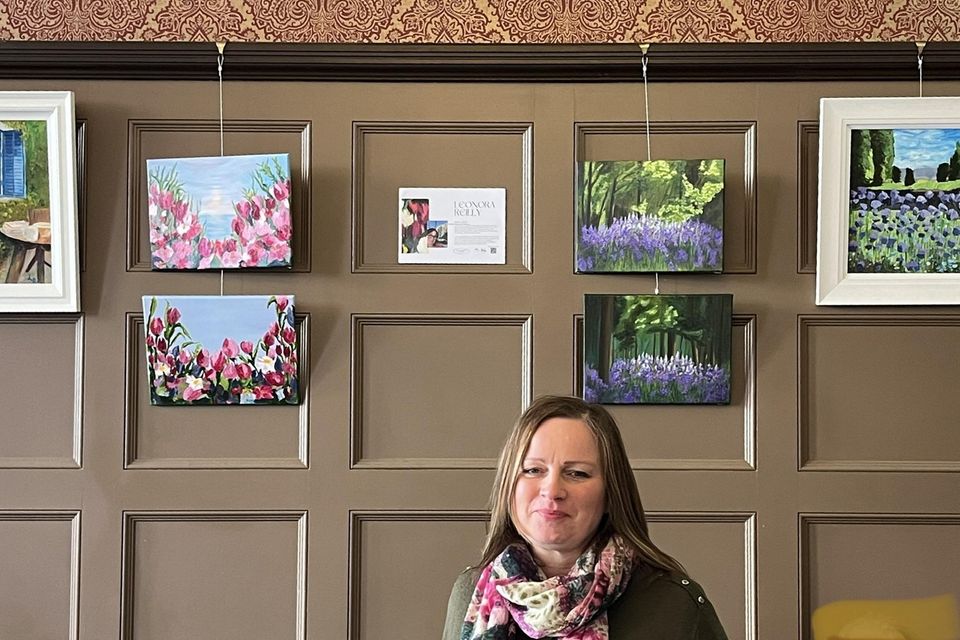 Local artist Leonora Reilly with some of the art on display in the Coffee House in West Street.