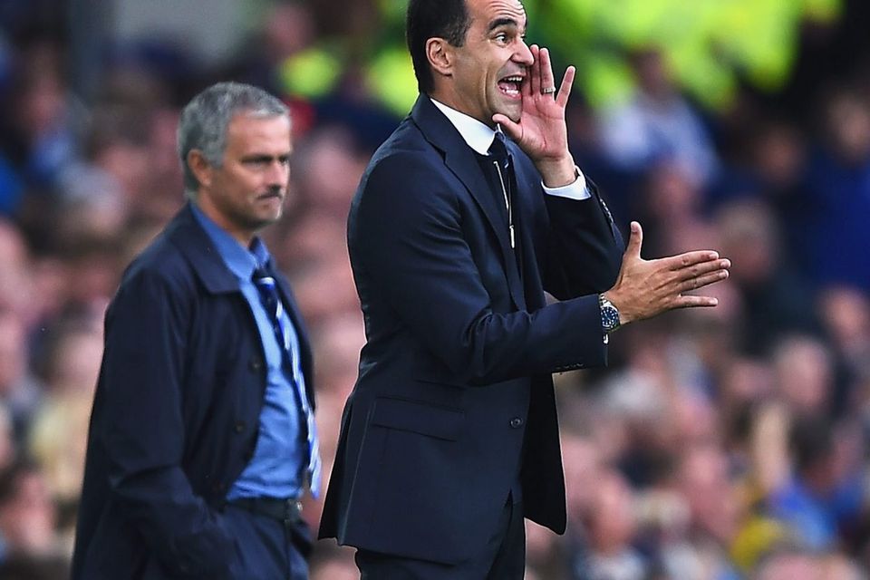 Roberto Martinez (R), manager of Everton gives instructions with Jose Mourinho, manager of Chelsea