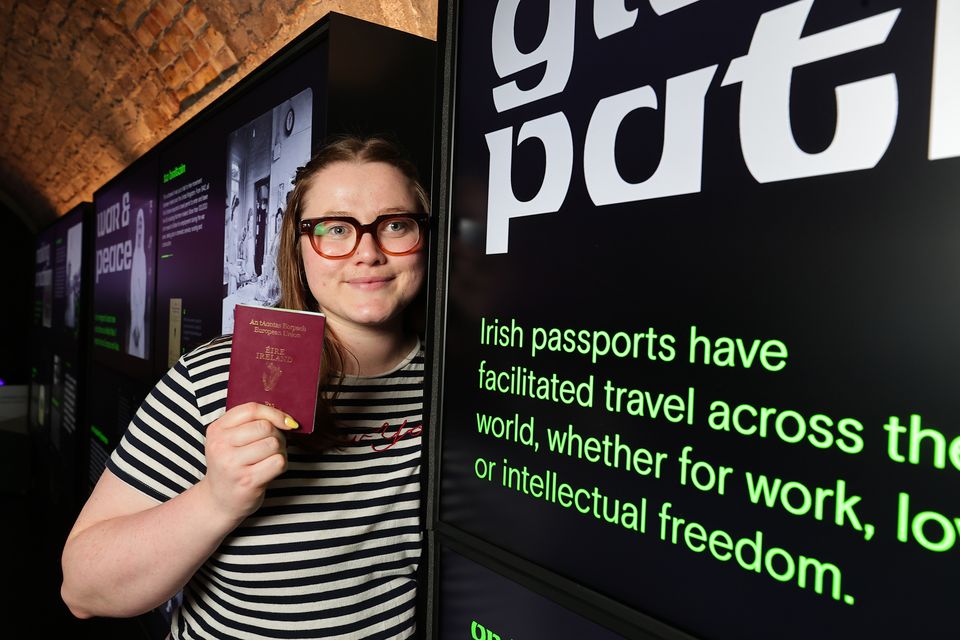 Saoirse Hanley with her passport at the 'On the Move' exhibition in the Epic museum. Photo: Gerry Mooney