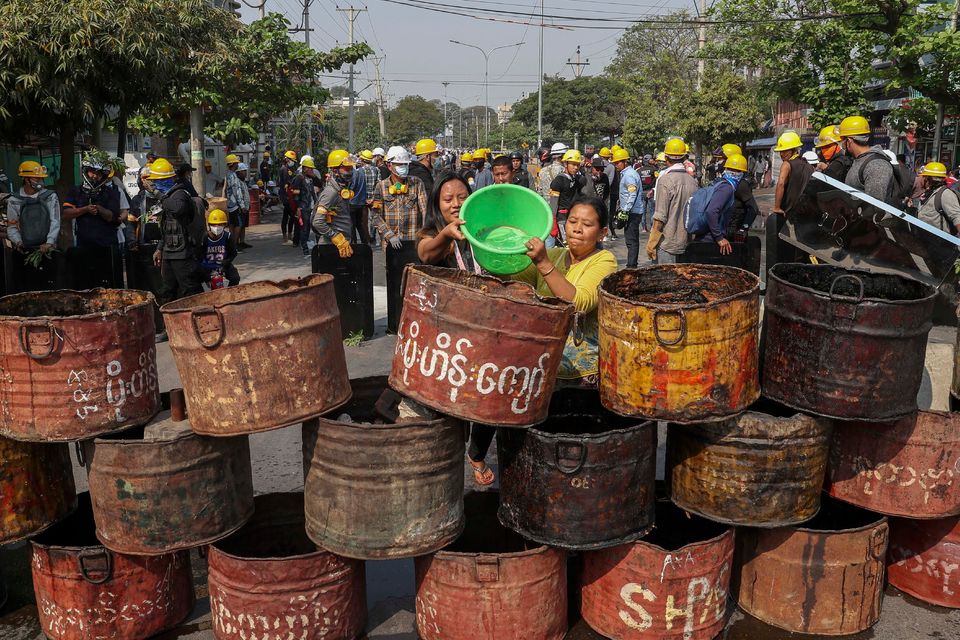People build barricades to deter security personnel from entering a protest area in Mandalay, Myanmar, yesterday. Photo: AP