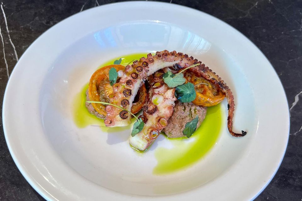 "There’s now a smart cocktail bar in situ, and the pink walls are flanked with comfortable brasserie-style banquette seating, where everyone can see everyone!" Grilled octopus, tapenade, slow roast tomato at Lottie's. Photo: Lucinda O'Sullivan