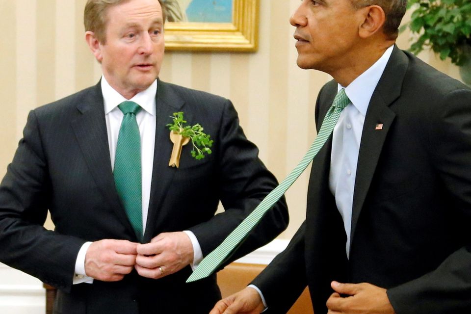 U.S. President Barack Obama (R) and Ireland's Prime Minister Enda Kenny button their jackets as they depart for a luncheon at the U.S. Capitol after their meeting in the Oval Office as part of a St. Patrick's Day visit at the White House in Washington March 17, 2015. REUTERS/Jonathan Ernst