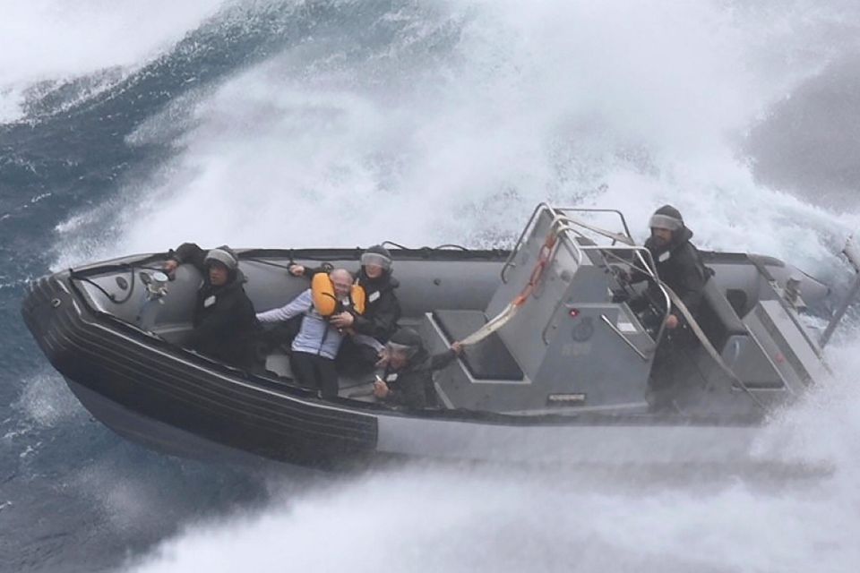 A seaboat carries a rescued sailor taken from his stricken yacht off New Zealand's North Island. Photo: New Zealand Defence Force