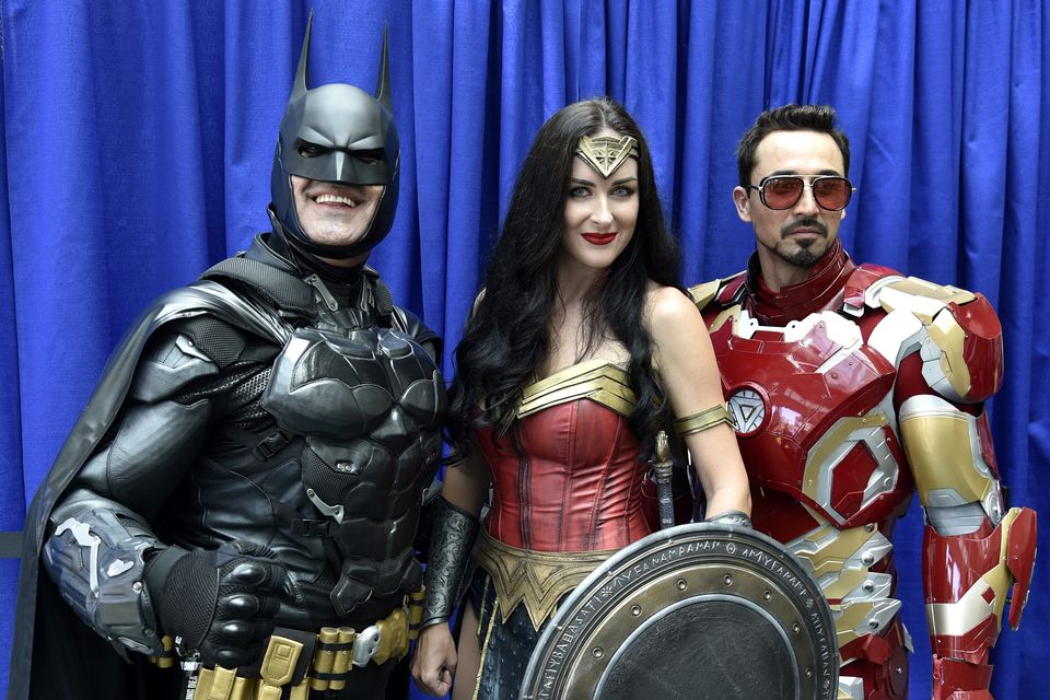 Armando Abarca, dressed as Batman, left, and Jessica Rose Davis, dressed as Wonder Woman, of Los Angeles, and Guillermo Gonzalez, of Sacramento, Calif., dressed as Iron Man (Chris Pizzello/Invision/AP)
