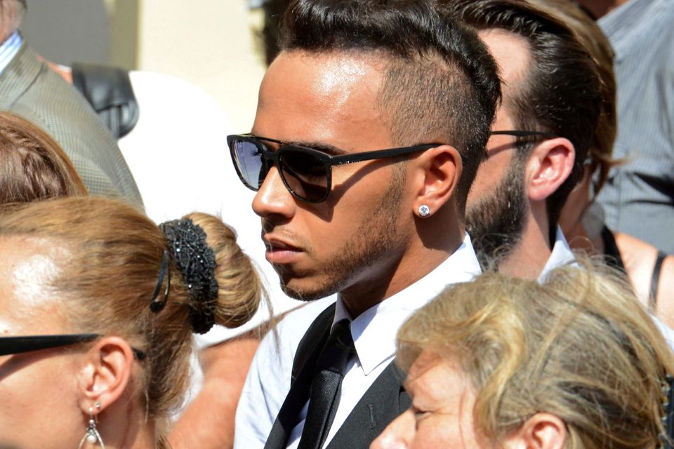 Formula One driver Lewis Hamilton leaves after the funeral ceremony for late Marussia F1 driver Jules Bianchi at the Sainte Reparate Cathedral in Nice, France, July 21, 2015. Bianchi, 25, died in hospital in Nice on Friday, nine months after his crash at Suzuka in Japan and without regaining consciousness.   REUTERS/Jean-Pierre Amet
