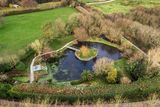 thumbnail: The pond and a viewing deck surround the island