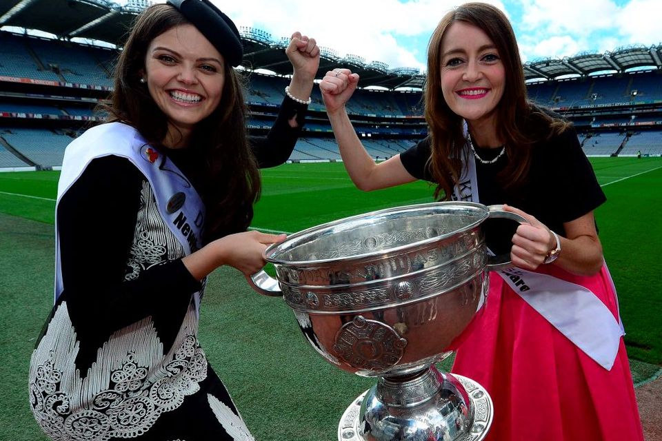 Dublin Rose Aisling Finnegan and Kerry Rose Julett Culloty do battle over the Sam Maguire cup during a visit to Croke Park. Photo: Domnick Walsh
