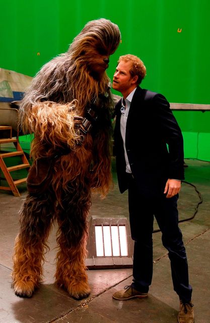 Britain's Prince Harry (R) speaks with Chewbacca during a tour of the Star Wars sets at Pinewood studios in Iver Heath, west of London on April 19, 2016.AFP PHOTO / ADRIAN DENNISADRIAN DENNIS/AFP/Getty Images