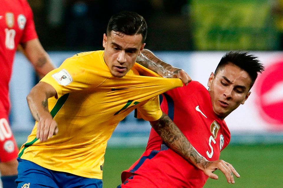 Brazil’s Philippe Coutinho (L) is tackled by Erick Pulgar of Chile during Tuesday night’s World Cup qualifier   Photo: Getty