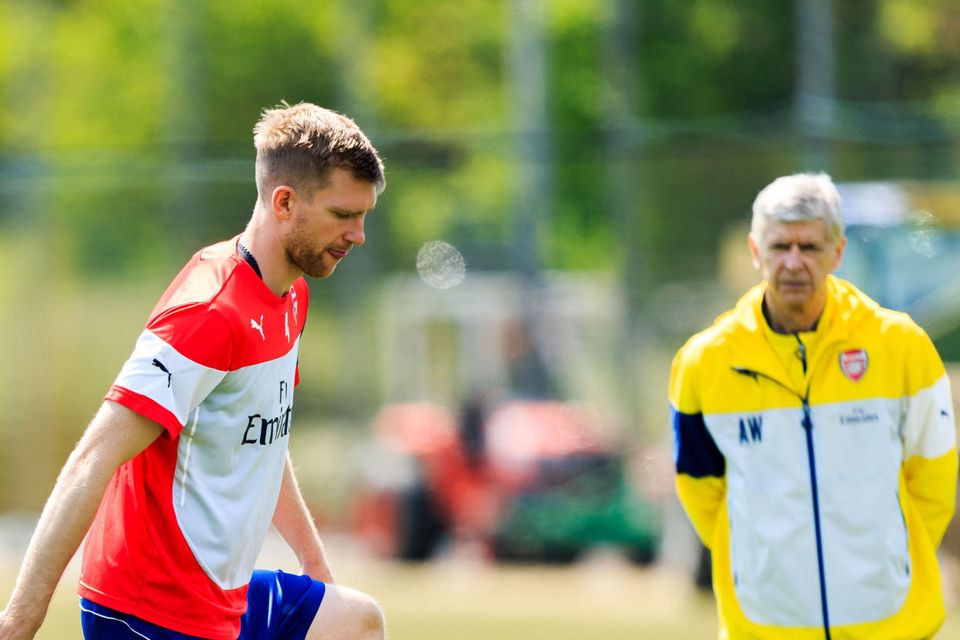 Arsenal club captain Per Mertesacker, left, is set to take on a role in charge of the Academy from 2018