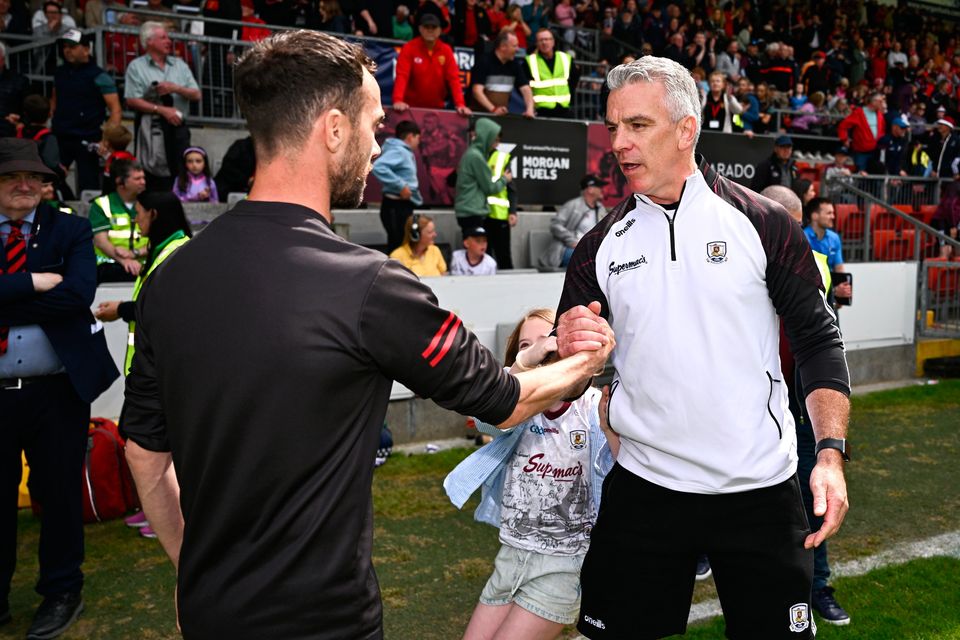 Down manager Conor Laverty, left, and Galway manager Pádraic Joyce shake hands after the All-Ireland SFC preliminary quarter-final at Páirc Esler in Newry, Down. Photo: Ben McShane/Sportsfile