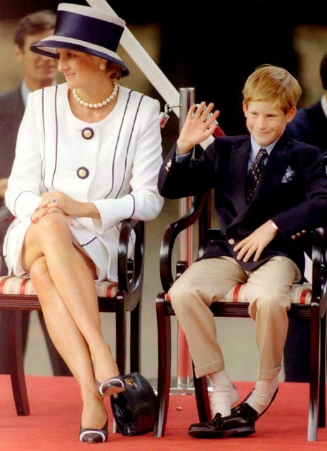 Princess Diana(L) and her son Harry(R) watch veterans as they march past a dais on the Mall as part of the commemorations of VJ Day 19 August.