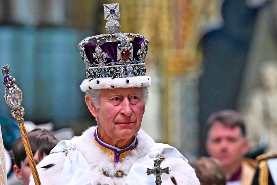 King Charles wearing the Imperial State Crown carrying the Sovereign's Orb and Sceptre yesterday. Photo: Ben Stansall