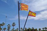 thumbnail: The Valencian flag flies alongside the Spanish flag on the beach in Valencia.