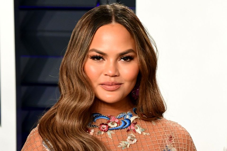 Chrissy Teigen threatens legal action against fashion designer in