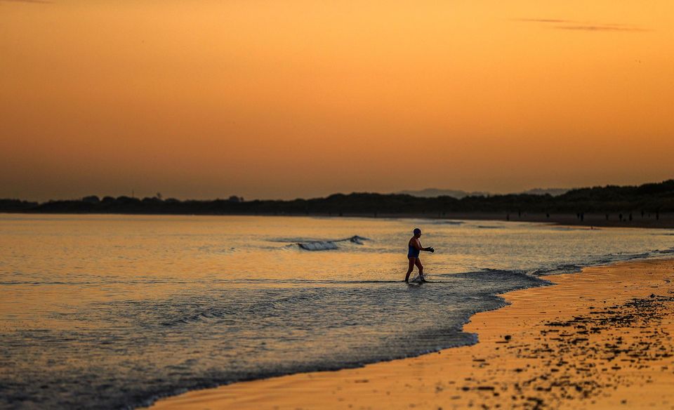 People enjoy going for a dip at Portmarnock Strand, Co Dublin. Photo: Gerry Mooney