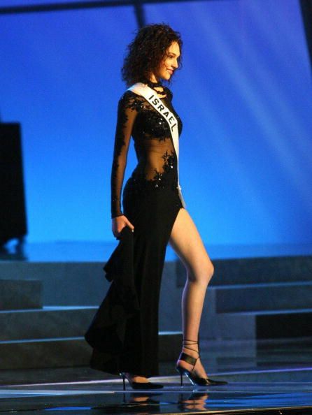 Miss Israel Gal Gadot walks on the stage in nightgown during the first official presentation with the panel of judges in Quito, 27 May 2004. The Miss Universe 2004 contest will take place on 01 June. AFP PHOTO/RODRIGO BUENDIA  (Photo credit: RODRIGO BUENDIA/AFP/Getty Images)