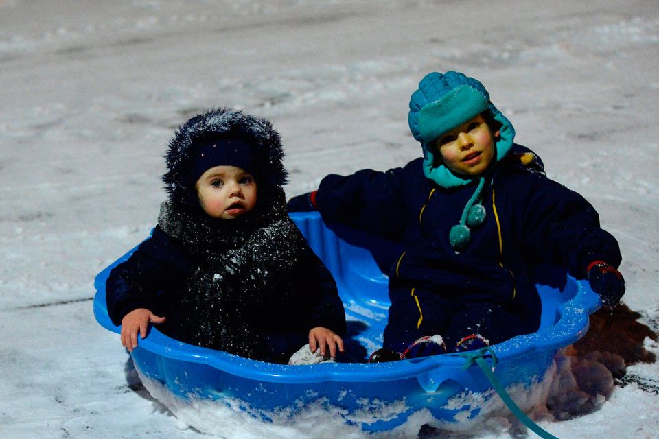 Tyanna Darcy, 2, left, and Sandrio Jiqia, 4, enjoy playing in the snow. Lanesborough, Finglas, Dublin. Picture: Caroline Quinn