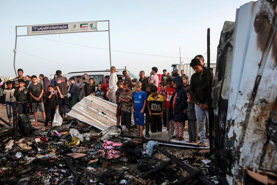 Palestinians look at the destruction after an Israeli strike where displaced people were staying in Rafah, southern Gaza. Health workers said at least 35 people were killed in the area. Photo: AP