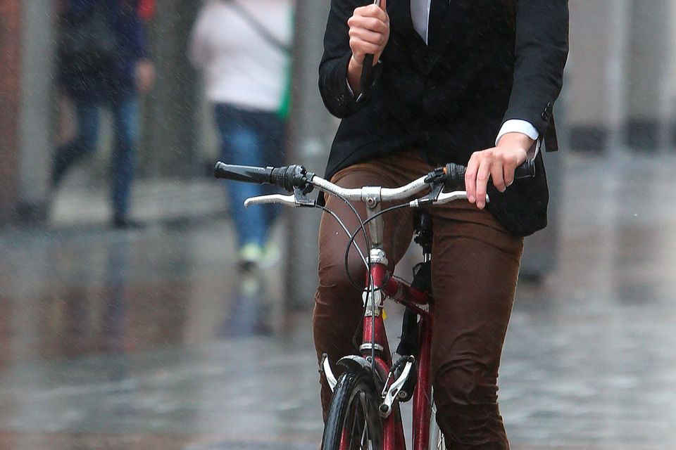 A cyclist keeps the rain off on Henry Street Dublin.