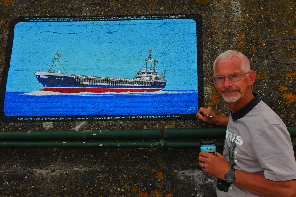 Pat Davis after completing his mural honoring the crew of the merchant ship Verity, which sank last year with the loss of five crew members.