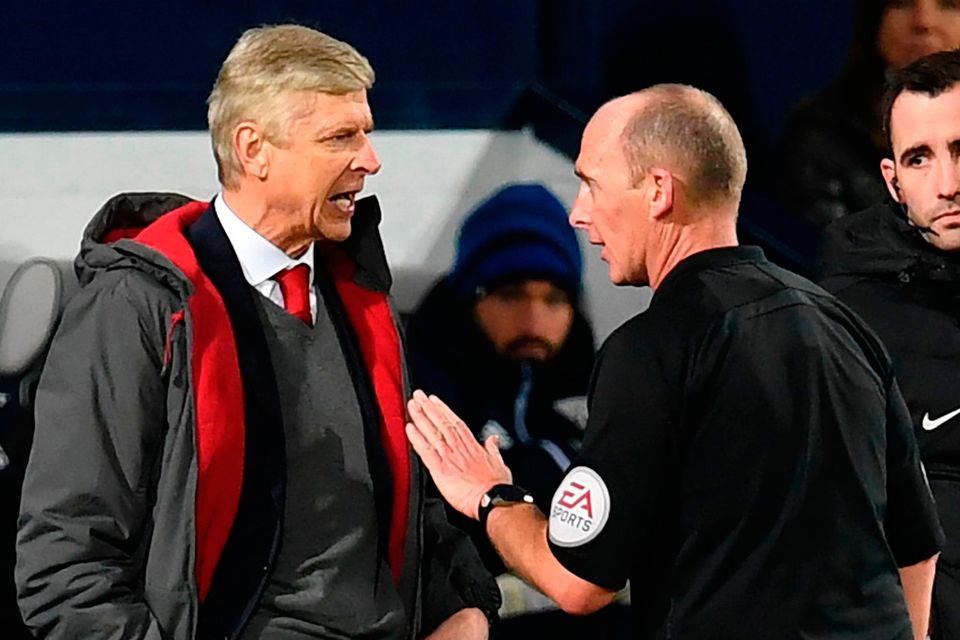 Arsene Wenger makes his views known to Mike Dean after the referee’s decision to award a penalty to West Brom on Sunday  Photo: Getty