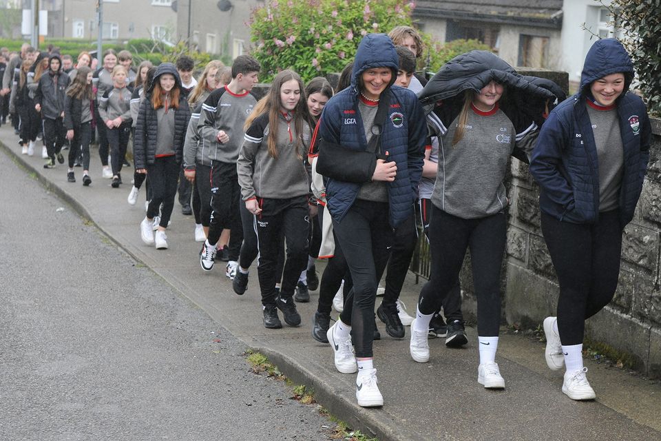 Students sheltering from a shower during the Creagh College 5km Walk in aid of the school's musical and Students Council on Monday. Pic: Jim Campbell