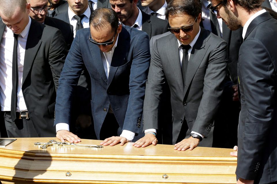 Formula one drivers Venezuela's Pastor Maldonado, second left, Brazilian Felipe Massa, second right and French Jean Eric Vergne, stand in front of the casket of French Formula One driver Jules Bianchi into Sainte Reparate Cathedral during his funeral in Nice, French Riviera, Tuesday, July 21, 2015. Bianchi, 25, died Friday from head injuries sustained in a crash at last year's Japanese Grand Prix. He had been in a coma since the Oct. 5 accident, in which he collided at high speed with a mobile crane which was being used to pick up another crashed car. (AP Photo/Lionel Cironneau)