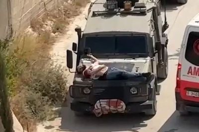 Outrage as Israeli troops strap injured Palestinian to bonnet of truck as ‘human shield’ – Irish Independent
