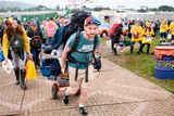 thumbnail: Festival-goers carry their belongings and tents to the camping areas as the gates are opened during day one of Glastonbury Festival at Worthy Farm, Pilton on June 26, 2019 in Glastonbury, England. (Photo by Leon Neal/Getty Images)