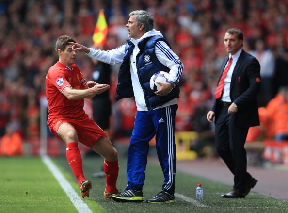 Steven Gerrard of Liverpool rushes in to retrieve the ball from Chelsea manager Jose Mourinho during the Barclays Premier League match between Liverpool and Chelsea at Anfield.