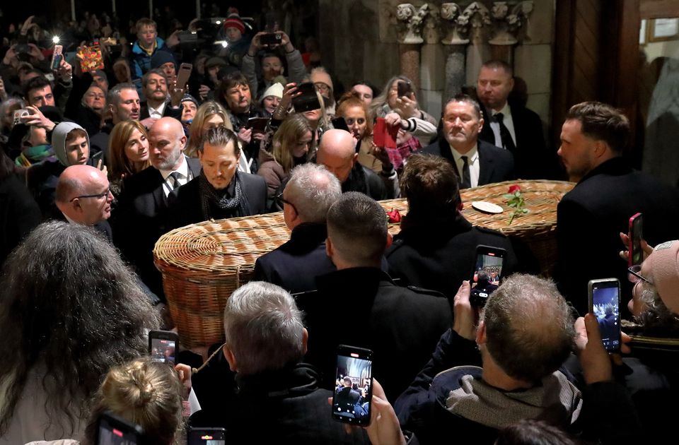 Johnny Depp (left) helps carry Shane MacGowan's coffin from the church in Nenagh. Photo: Frank McGrath